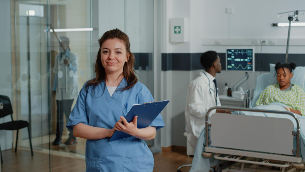 Healthcare assistant supporting a patient with documents in a hospital ward