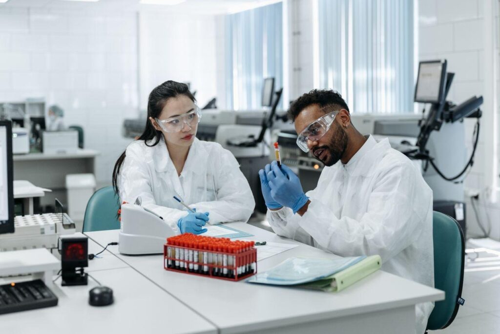 Laboratory researchers examining and recording a test sample